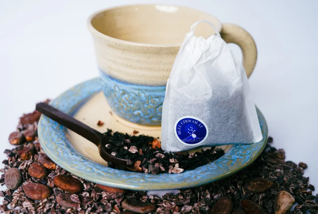Tea cup with a tea bag and spoon on a white background