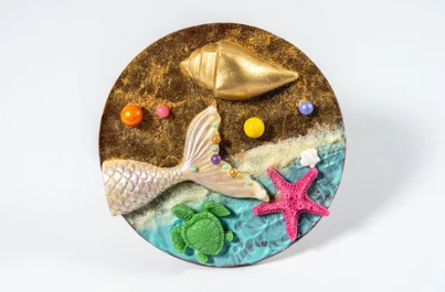 Decorative circular piece with sea-themed elements on a white background